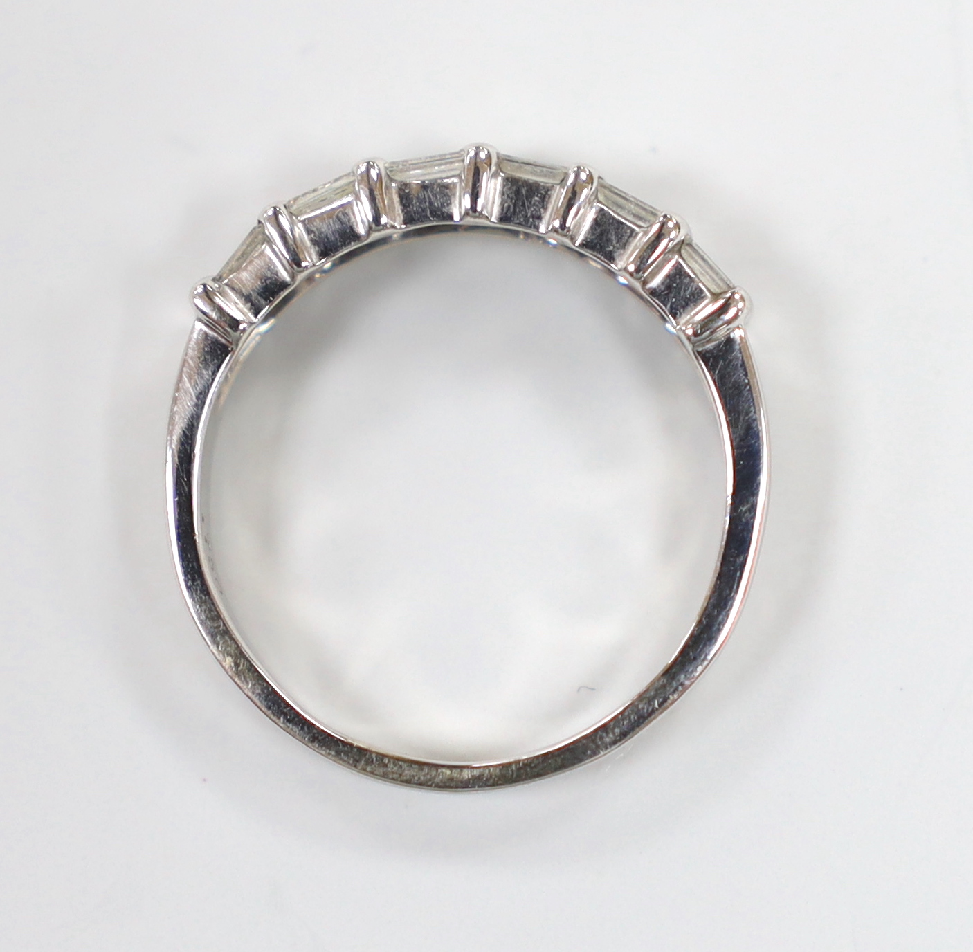 A modern 18ct white gold and two row baguette cut diamond cluster set half hoop ring, size P/Q, gross weight 4.1 grams.